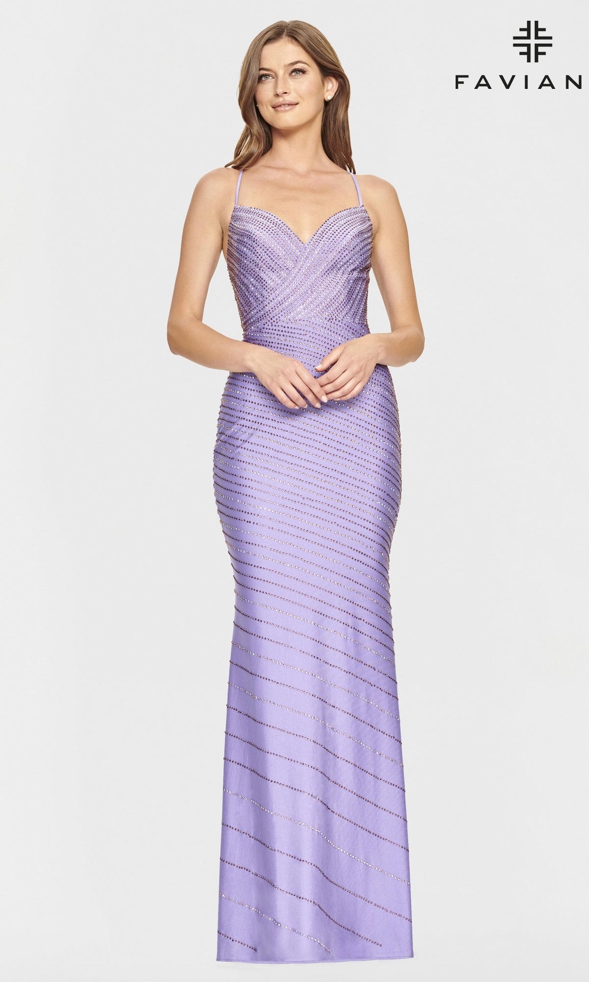 A woman models the Backless Beaded Stretch Formal Dress by Faviana—fitted, floor-length, lavender with thin straps, diagonal bead patterns, and open back—against a plain white background featuring the Faviana logo.